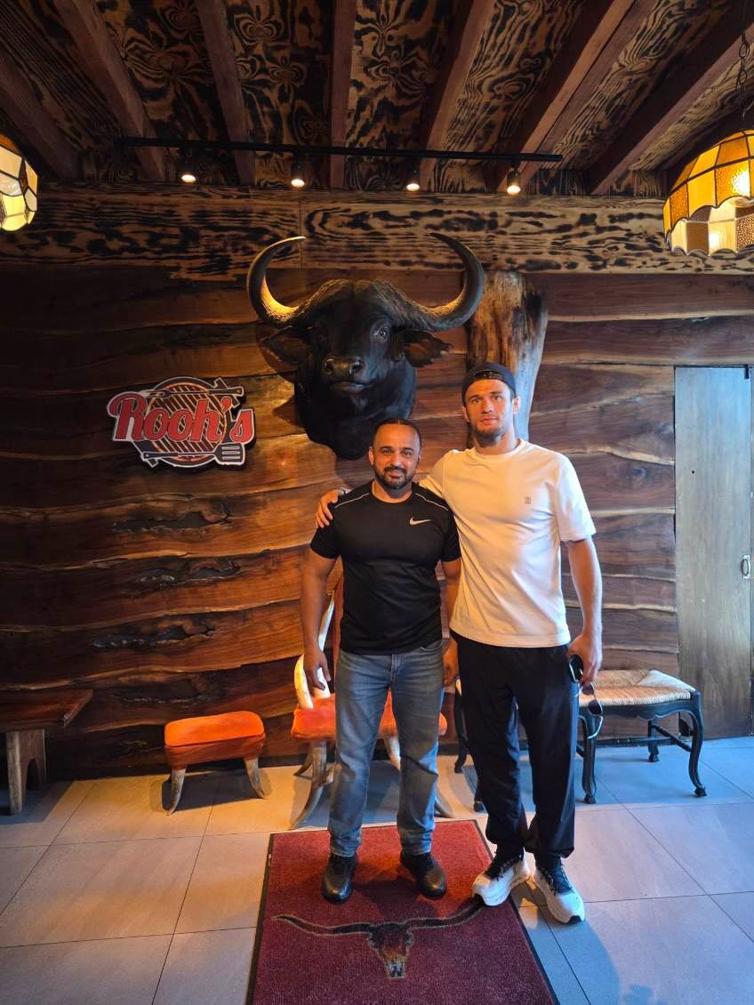 Rahim and Usman Nurmagomedov in front of the Rooh's sign and buffalo head