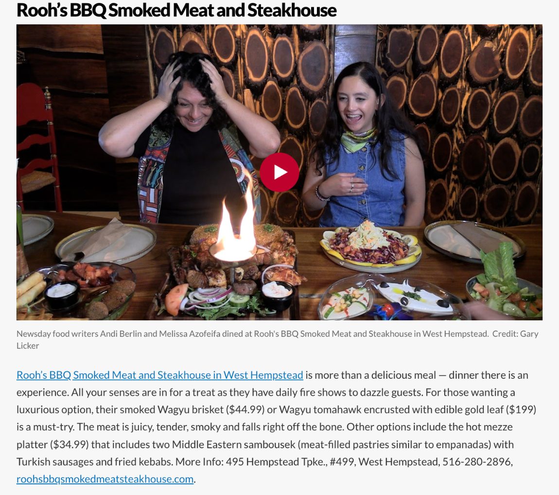 Rooh's entry in Newsday's 21 best things we ate on Long Island in 2025, with Newsday's food writers at a table with a flaming platter